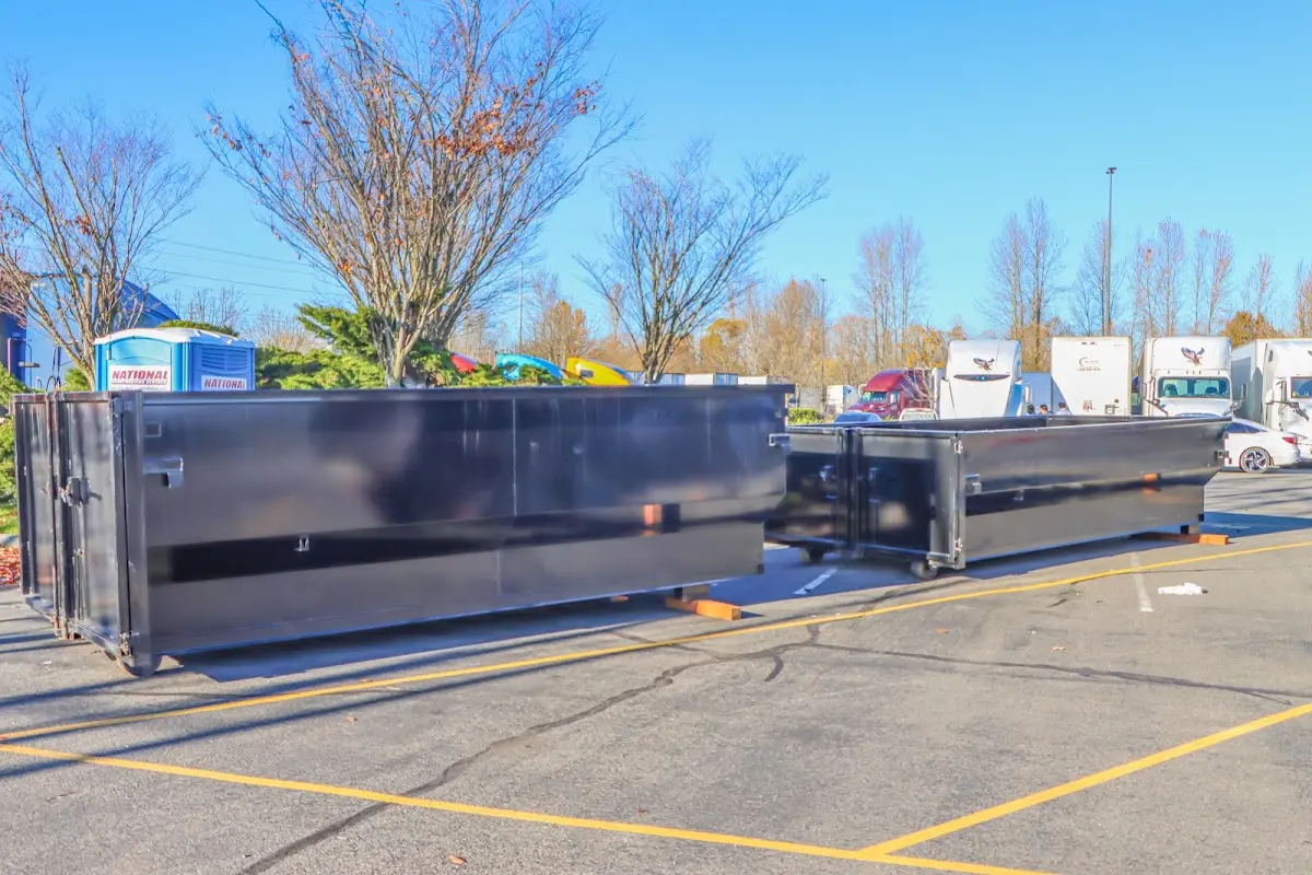 Professional dumpster rental service with roll-off container on residential driveway in Skaneateles